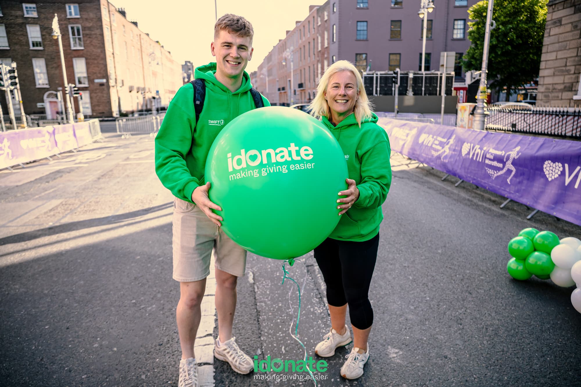 iDonate team supporting causes across Ireland at a fundraising event with a green iDonate balloon